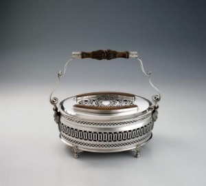 silver warmer of oval shape, standing on four ball and foliate feet, pierced on the body and on the lid, scroll handle,