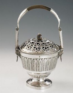 silver warmer of circular shape standing on a plain feet, body gadrooned and with large floral band, pierced lid and bud finial