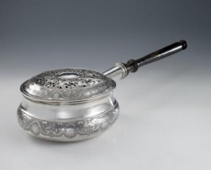 silver bed warmer of circular shape with ebonized turned wood handle, large chiselled band on the body and on the lid