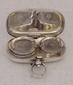 silver sovereign holder in locket shape